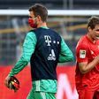 Bayern Munich's Thomas Mueller elbow bumps substitute goalkeeper Sven Ulreich after the Borussia Dortmund win