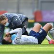 Injured - Aston Villa midfielder Trezeguet receives medical attention during a Premier League match against Liverpool at Anfield on Saturday