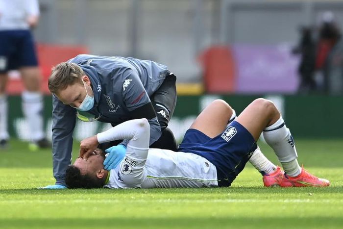Injured - Aston Villa midfielder Trezeguet receives medical attention during a Premier League match against Liverpool at Anfield on Saturday
