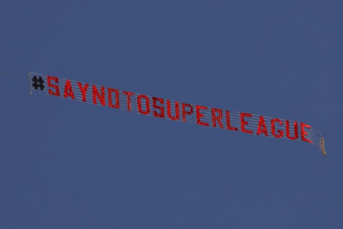 A plane flies above  Elland Road in Leeds before the Premier League game against Liverpool protesting against the planned Super League