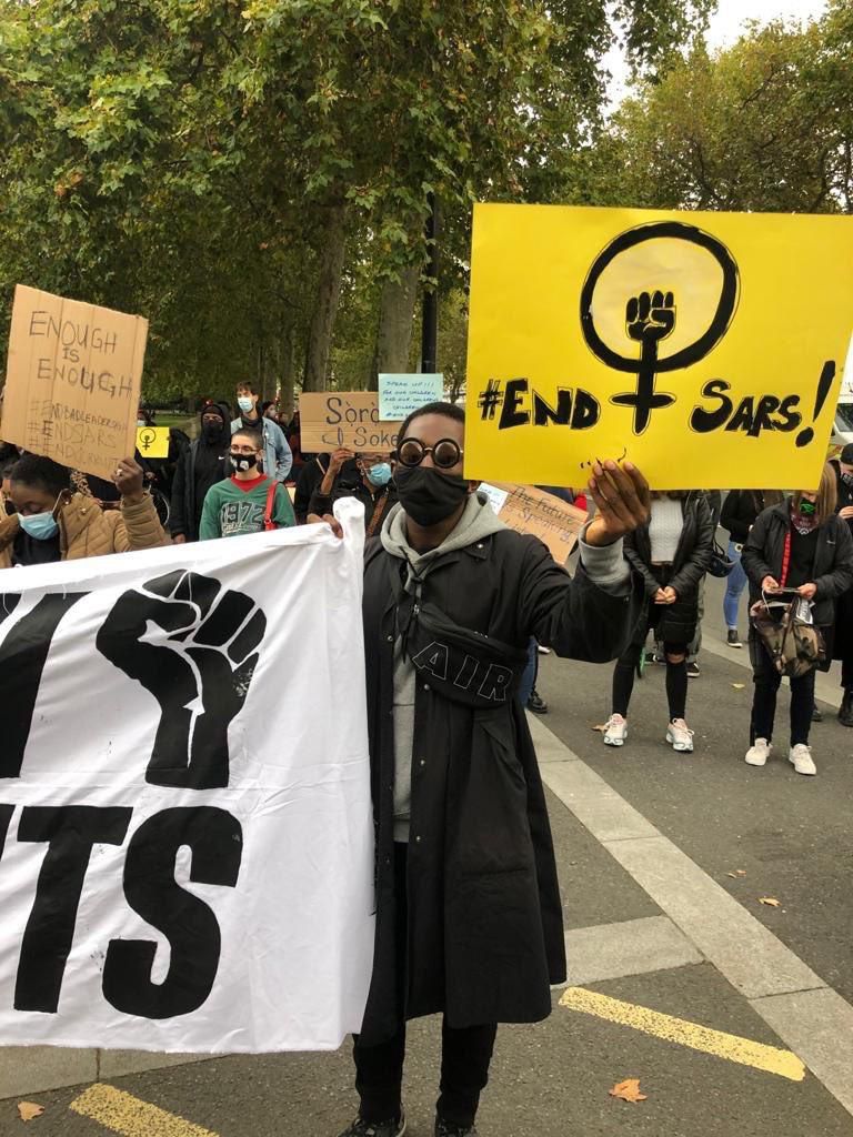Feminist coalition insignia being held during the #EndSARS protest abroad (Twitter: @feminist_co)