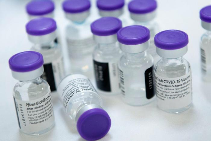Vials of undiluted Pfizer COVID-19 vaccine are prepared to administer to staff and residents at a senior living community in Falls Church, Virginia, on December 30, 2020.