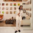 Burna Boy poses against the backdrop of old records for Architectural Digest