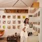 Burna Boy poses against the backdrop of old records for Architectural Digest