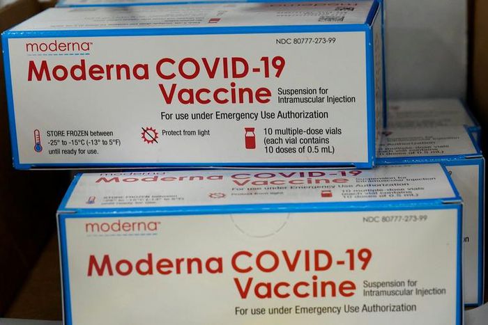 Boxes containing the Moderna COVID-19 vaccine are prepared to be shipped.