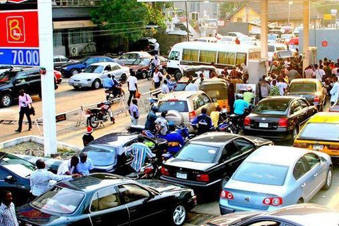 An illustrative photo of Nigerians queueing to buy petrol.