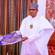Governor Babajide Sanwo-Olu presenting pictures of the recent destruction of Lagos by hoodlums to President Muhammadu Buhari in Abuja on Friday, November 6, 2020 (Presidency)