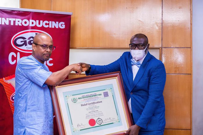 L-R: Dr Oladele Ajayi, MD/CEO, UAC Foods LTD receiving the Halal certification for the company's flagship sausage roll brand, Gala, from Abdulazeez Ajala, Lead Auditor, Halal Certification Authority in Nigeria.