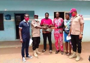 Second from left, the  FRSC Unit Commander in Oraifite, Mr Bamidele Ayanwale,  presenting the cash to the  family of the deceased on Tuesday. [NAN]
