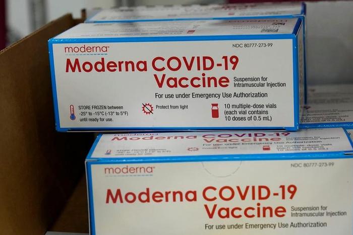 Boxes containing the Moderna COVID-19 vaccine are prepared to be shipped.