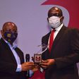 The Editor, Independent Newspapers, Don Okere Presenting the Bank of the Year Award to Directorate Head, Lagos Island, United Bank for Africa, Uzoechina Molokwu