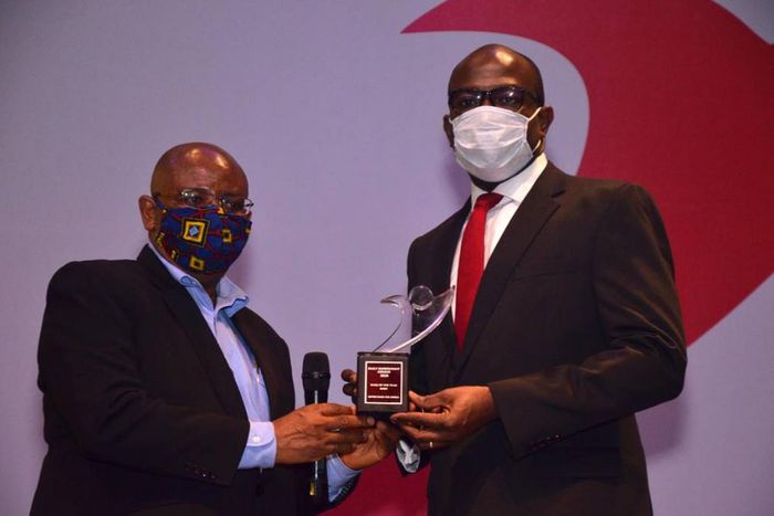 The Editor, Independent Newspapers, Don Okere Presenting the Bank of the Year Award to Directorate Head, Lagos Island, United Bank for Africa, Uzoechina Molokwu