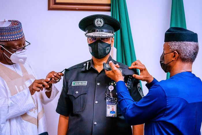 Vice President Osinbajo decorates new acting IGP Usman Baba at the State House Abuja on Wednesday April 7, 2021 (Tolani Alli)