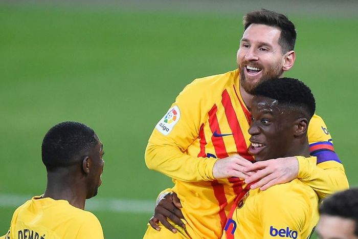 Ilaix Moriba (R) celebrates with Lionel Messi after scoring Barcelona's second goal against Osasuna on Saturday
