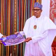 Governor Babajide Sanwo-Olu shows President Muhammadu Buhari a photo album of destruction recorded in Lagos during #EndSARS protests in October 2020. (Presidency)