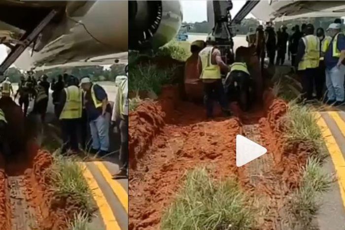Airplane gets stuck in mud after skidding off the runway