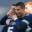 Cristiano Ronaldo (R) congratulates Brazilian midfielder Arthur who scored his first goal for Juventus
