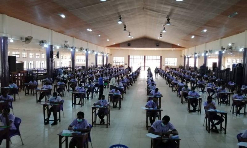 Student writing WASSCE WAEC