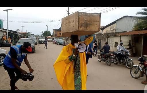 Archbishop Samson Benjamin embarks on a one-man protest with a coffin on his head