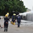 Firemen spraying water to avert fire at the scene of a tanker loaded with cooking gas that fell on Constitution Avenue at Centre Business District in Abuja on Wednesday. [NAN]