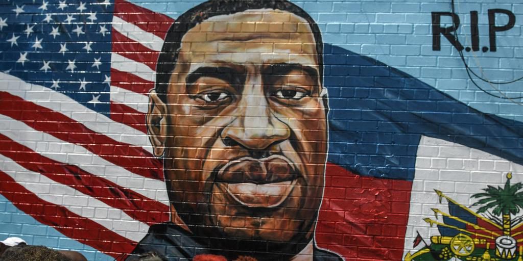 A mural painted by artist Kenny Altidor depicting George Floyd is unveiled on a sidewall of CTown Supermarket on July 13, 2020 in the Brooklyn borough New York City.