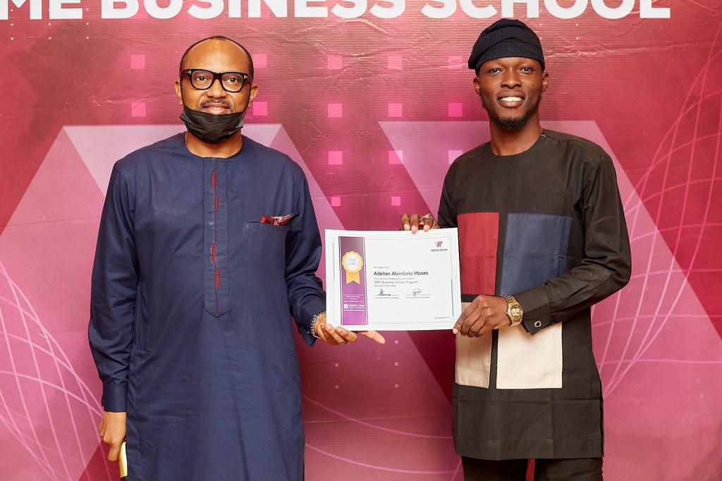 A happy beneficiary receiving his certificate