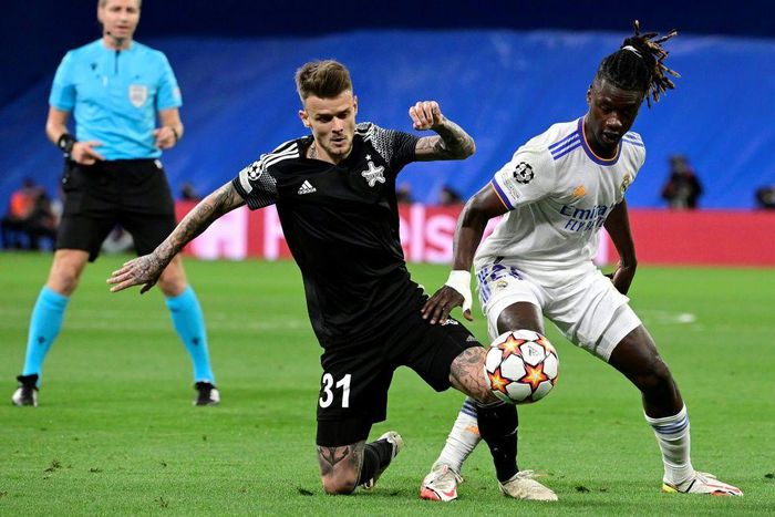 Sebastien Thill, in black, battling with Real Madrid's 30-million euro teenage midfielder Eduardo Camavinga