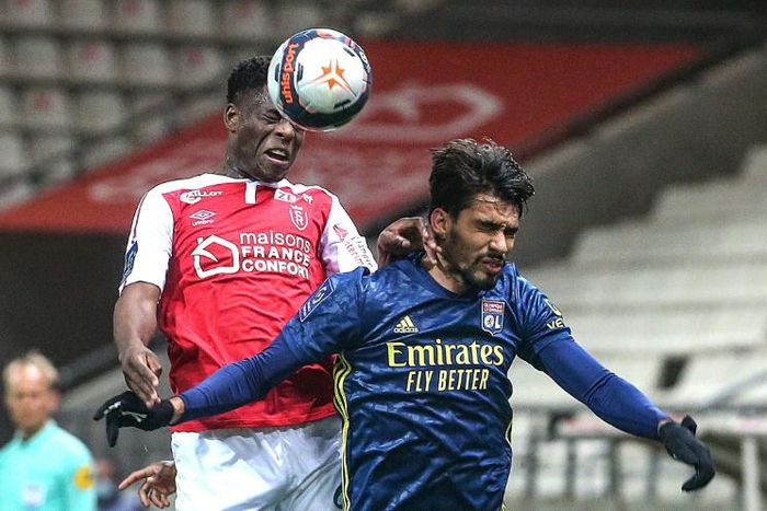 High life: Reims' Zimbabwean midfielder Marshall Munetsi jumps for the ball with Lyon midfielder Lucas Paqueta