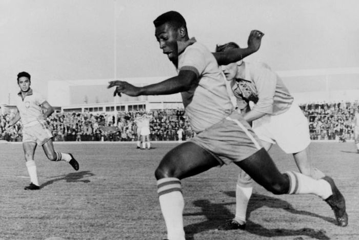 In this photo taken on May 8, 1960, Brazilian football legend Pele dribbles past a defender during a friendly match between Malmoe and Brazil, in Sweden