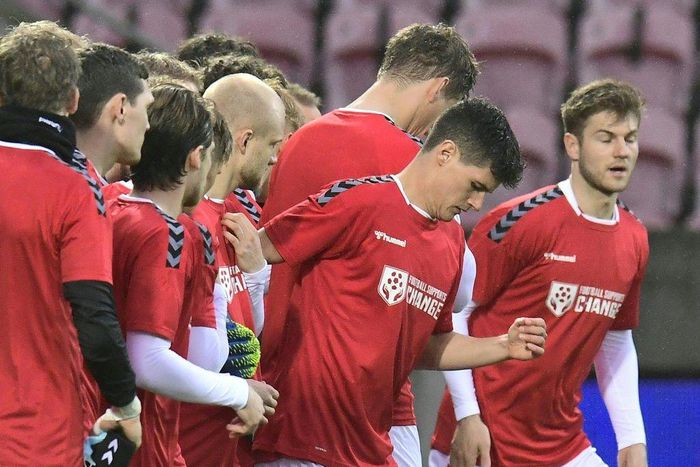 Denmark players wearing T-shirts with "Football supports change" written on them before the win over Moldova on March 28