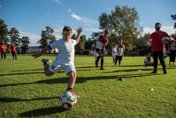 A child kicks a ball at the new football school for children with learning difficulties set up by Argentine team Newell's Old Boys