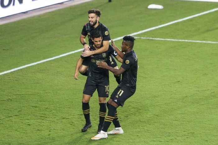 Los Angeles FC talisman Carlos Vela is mobbed by team-mates during Saturday's CONCACAF Champions League semi-final win over Mexico's Club America