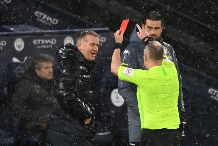 Referee Jon Moss (R) shows a red card to Aston Villa manager Dean Smith (L) during a 2-0 loss away to Manchester City on January 20