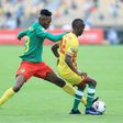 Thierry Tchuente (L) of Cameroon contests possession with Leeroy Mavunga of Zimbabwe during the African Nations Championship opener in Yaounde Saturday.