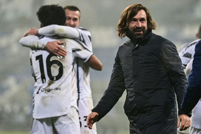 Andrea Pirlo (R) celebrates his first  coaching trophy as Juventus beat Napoli in the Italian Super Cup.