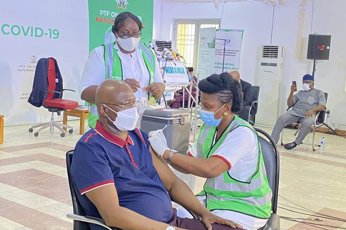 Chairman Presidential Task Force (PTF) on COVID-19 and Secretary General of the Federation, Boss Mustapha receives his first jab of COVID-19 vaccine. [Twitter/@NphcdaNG]