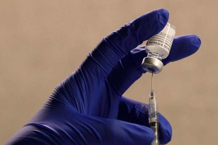 A pharmacist fills a syringe to prepare a dose of the Pfizer-BioNTech Covid-19 vaccine for front-line health care workers at a vaccination site at Torrance Memorial Medical Center on December 19, 2020 in Torrance, California.