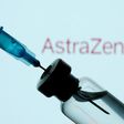 A vial and syringe in front of an AstraZeneca logo, January 11, 2021.