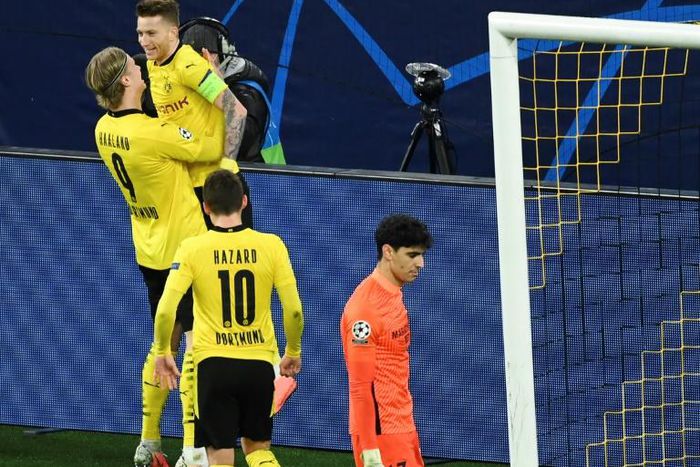 Erling Braut Haaland (L) celebrates scoring Borussia Dortmund's opening goal by lifting teammate Marco Reus off his feet