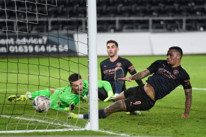 Four-midable: Manchester City are still alive in four competitions are beating Swansea to reach the FA Cup quarter-finals