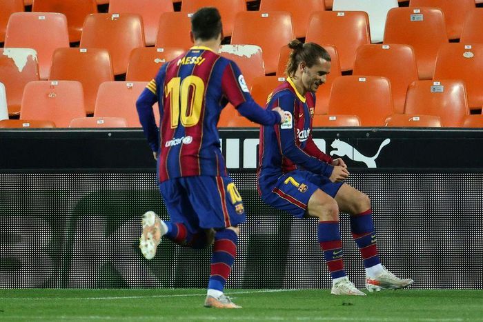 Team work: Lionel Messi runs to celebrate with Antoine Griezmann