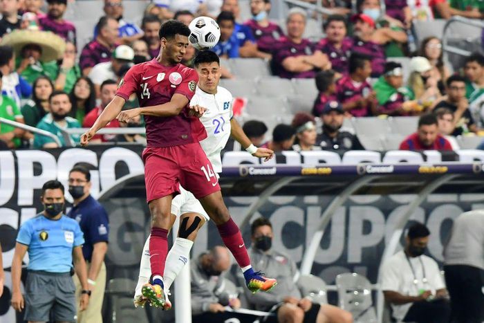 Qatar's Homam Ahmed, left, battles for a header with El Salvador's Bryan Tamacas during the Concacaf Gold Cup quarter-final match in Arizona