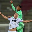 Arms race: Augsburg defender Raphael Framberger (left) challenges Moenchengladbach midfielder Valentino Lazaro