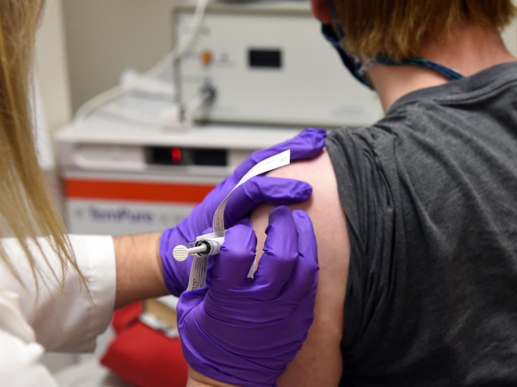 A volunteer receives an experimental vaccine for the coronavirus as part of a Pfizer clinical trial at the University of Maryland.