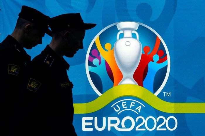 Police officers walking past a UEFA Euro 2020 in Saint Petersburg