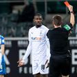 Moenchengladbach forward Marcus Thuram is shown a red card for spitting at an opponent on Saturday