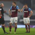 Referee Mike Dean shows West Ham's Tomas Soucek a red card