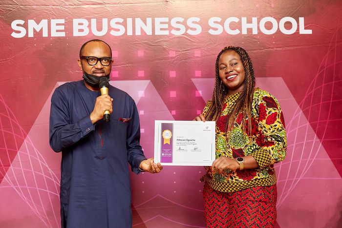 A Happy Beneficiary receiving her certificate