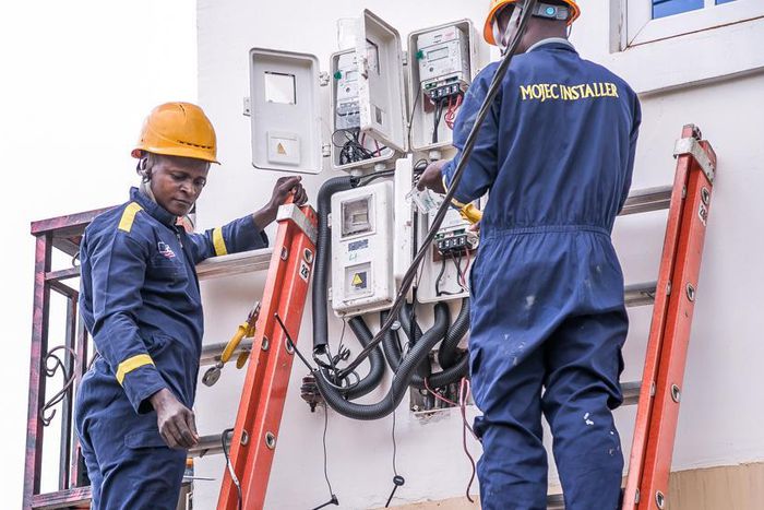 Electricity workers installing prepaid meters in homes. [NAN]