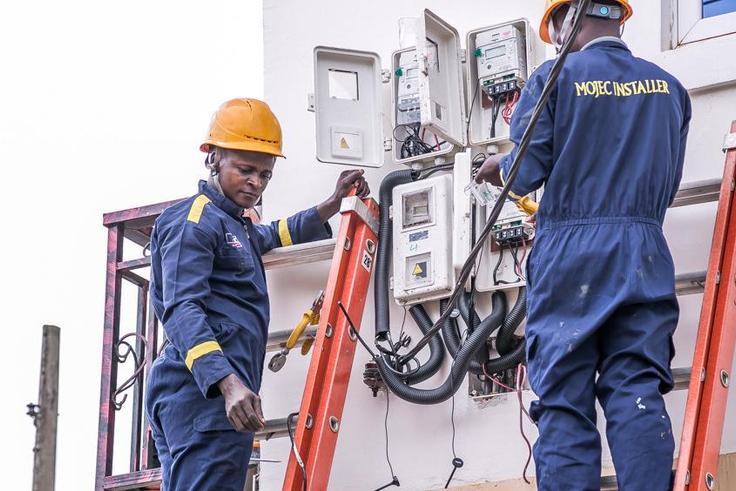 Electricity workers installing prepaid meters in homes. [NAN]